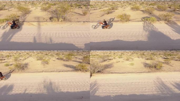 棕榈泉的泥土路上骑摩托车的人
