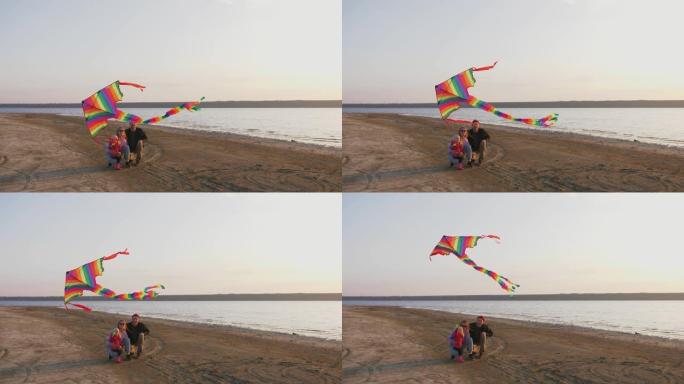 日落时海边放风筝的幸福家庭，慢动作