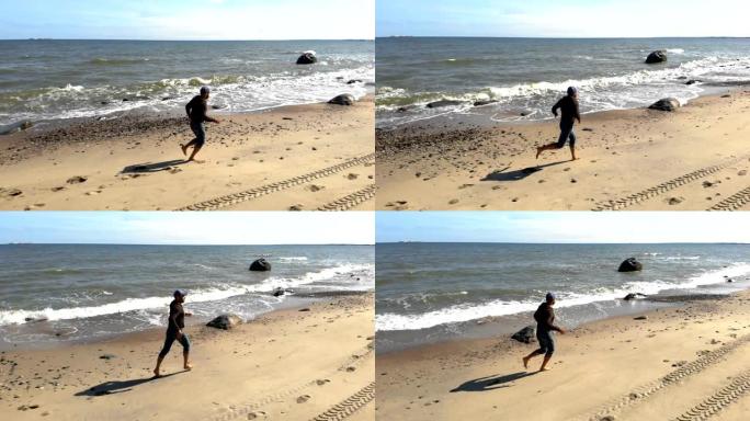 年轻的潮人在野外海滩上奔跑的鸟瞰图。在海边奔跑的人。在水上奔跑。野生自然。4K UHD。空中。人在天