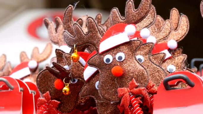 新年和圣诞节的箍在头上，以鹿的形式戴着圣诞老人的帽子和耳朵上的铃铛