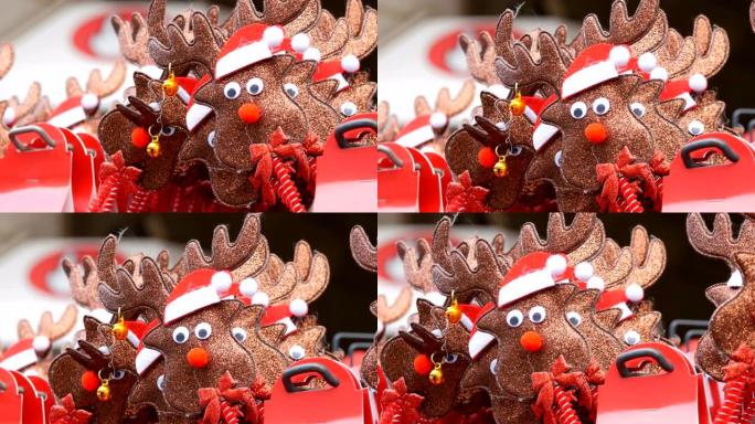 新年和圣诞节的箍在头上，以鹿的形式戴着圣诞老人的帽子和耳朵上的铃铛