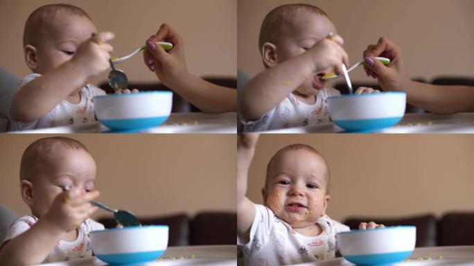 妈妈用勺子喂她可爱的小宝宝