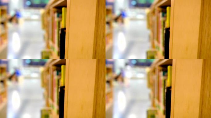 图书馆里有很多书籍和木制书柜。模糊的背景是人们正在寻找书籍。重点在右边。