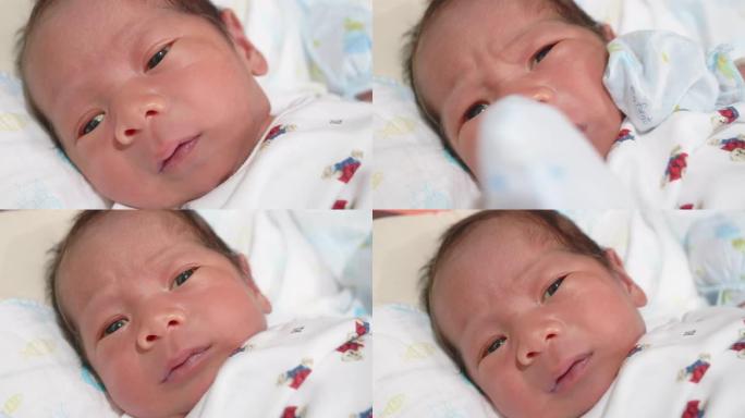 婴儿; 新生男婴面对欧亚种族的特写。