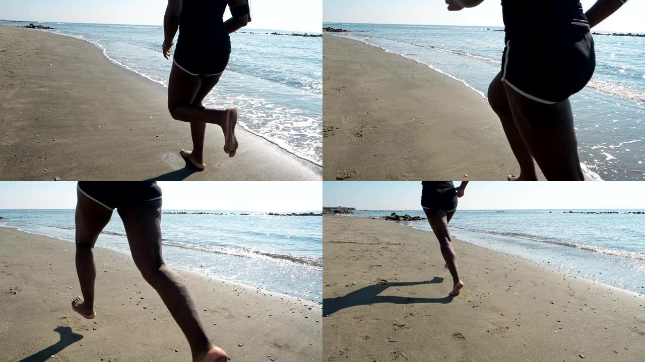 年轻的非洲黑人运动员在沙滩上奔跑。力量，训练，意志力