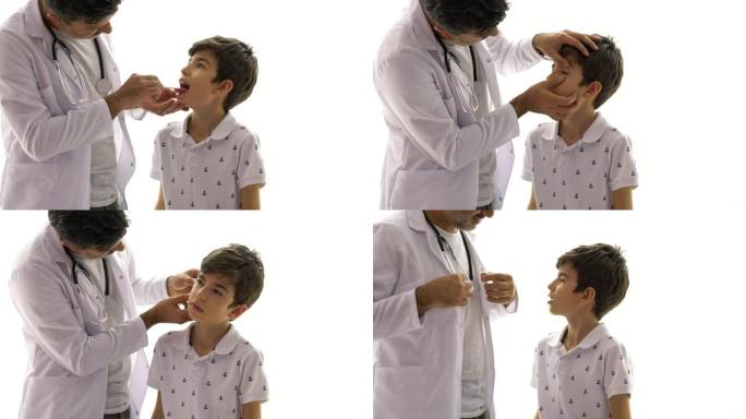 中年儿科医生在医院检查患有压舌板的男孩患者