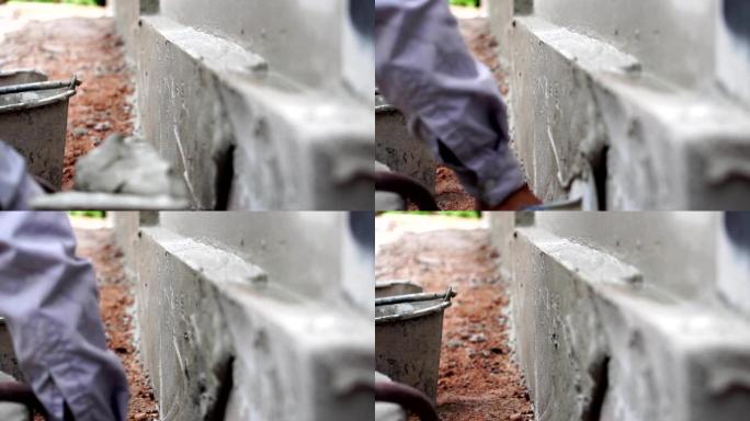 脚步慢动作: 建筑工人修整一堵墙
