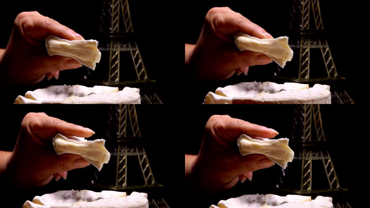 手指挤压一片柔软的法国奶酪