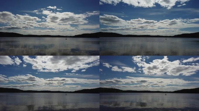 湖上云层的时间流逝，背景是森林。芬兰自然