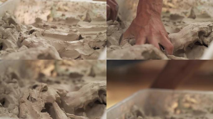 陶工为陶器准备材料粘土的特写镜头。人在成型前揉粘土。男性雕塑家正在他的工作室里拿粘土来制作陶瓷