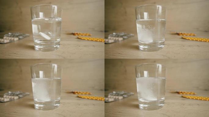 片剂或维生素掉落并溶解在白色背景下的一杯水中，慢动作4K