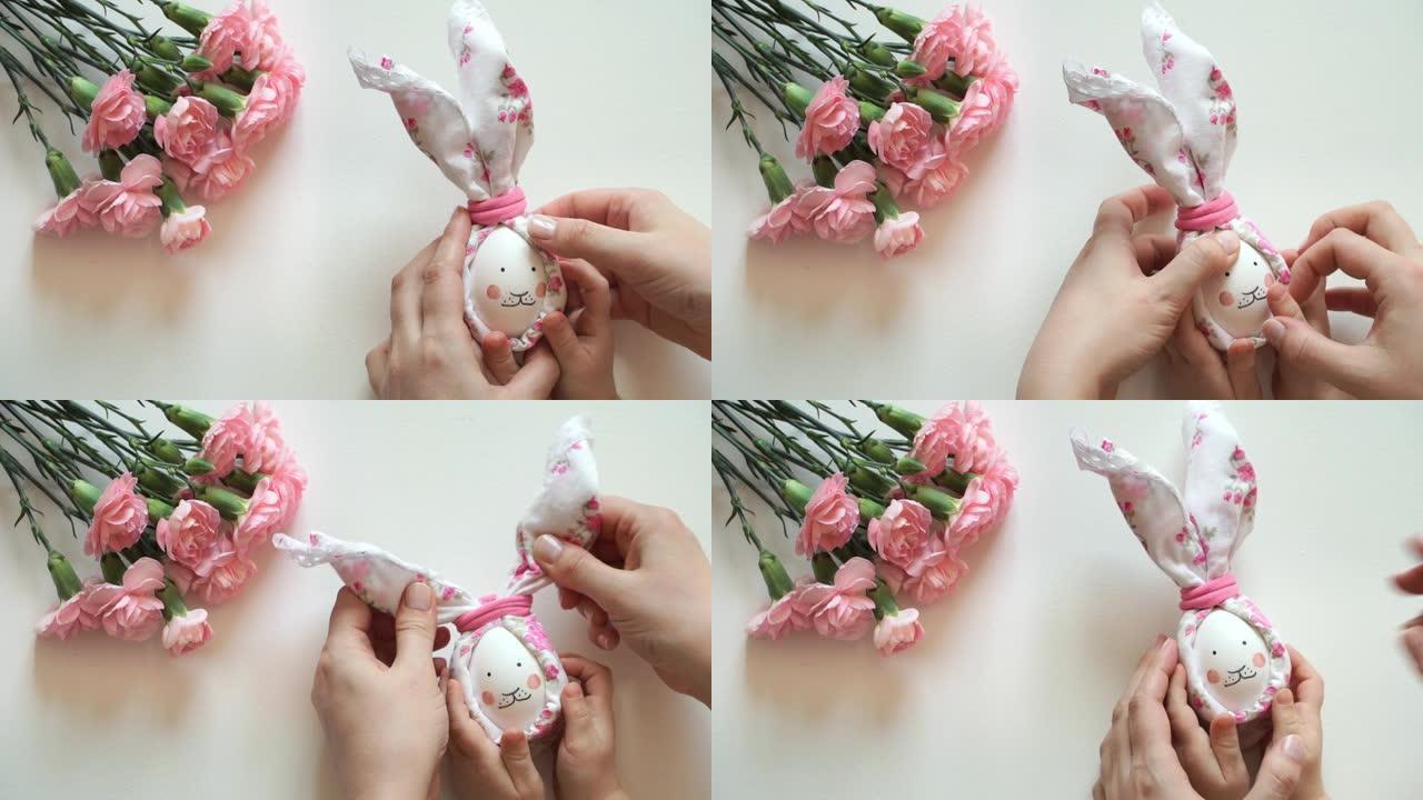 妇女和儿童的手为复活节兔子做鸡蛋装饰，用围巾涂上脸和耳朵。
