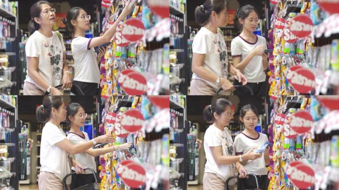 亚洲家庭母亲和少女在销售商店购物中心享受假期购物