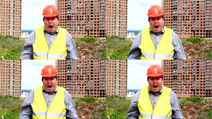 建筑工地上的男性建筑工人工头，工人或建筑师正在大喊并注视着镜头