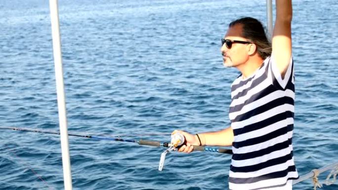 男子在暑假在船上钓鱼
