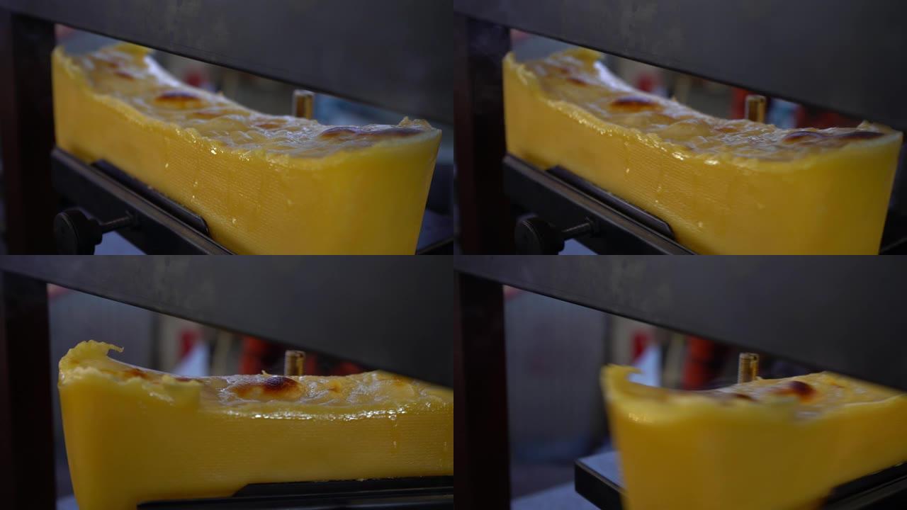 刮融化的传统瑞士Raclette奶酪