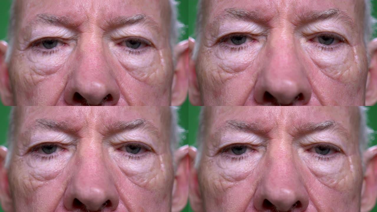 老年高加索男性脸部特写镜头，背景孤立在绿色上