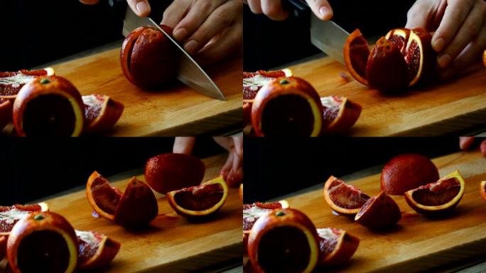 在木板上手工切成橙色。女人年轻的家庭主妇在家里的厨房里切新鲜的橙色水果