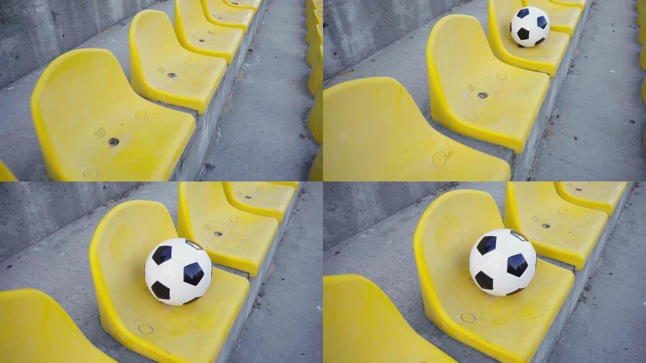 足球在体育场的领奖台上。空黄色椅子