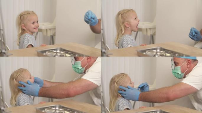 一个女孩去看医生耳鼻喉科医生。儿科医生为他可爱的小病人做喉咙检查