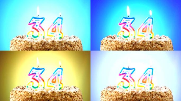 带有燃烧的生日蜡烛的生日蛋糕。34号。背景改变颜色