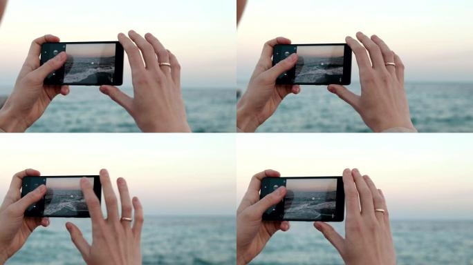 女性双手握着手机拍摄大海沙滩特写慢动作