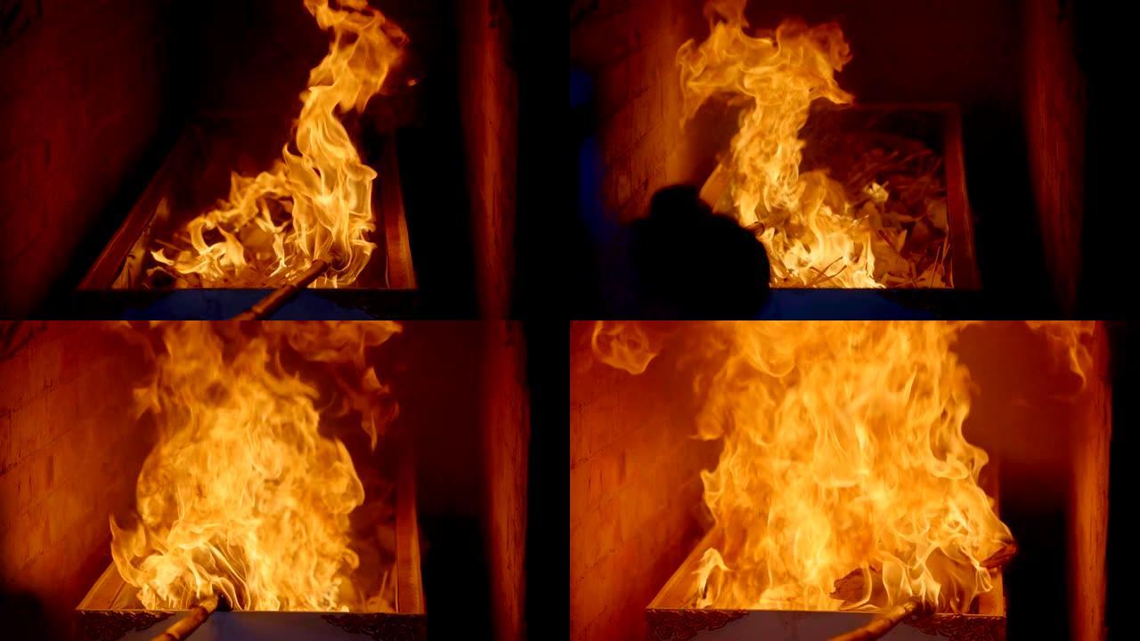 慢动作火火焰燃烧死者棺材火化，篝火火焰在燃料和檀香黑色背景上发光
