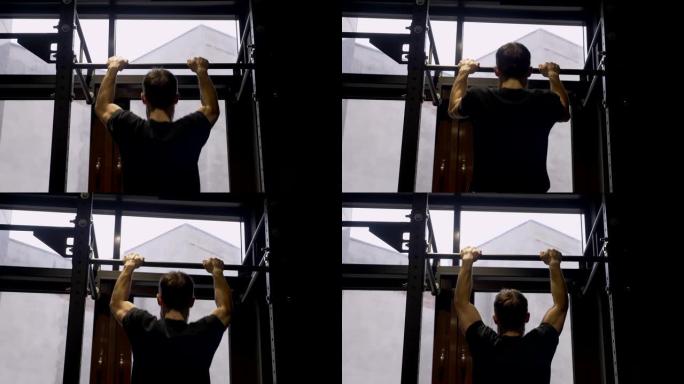 成人肌肉发达的运动员在健身房室内的酒吧里举起自己的特写镜头