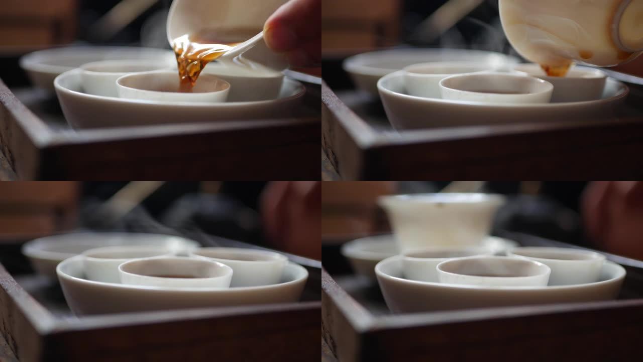 茶师将发酵的绿茶倒入茶杯中，以供盖碗或钟。中国传统功夫或功夫茶道。中国传统文化的元素。特写。4k