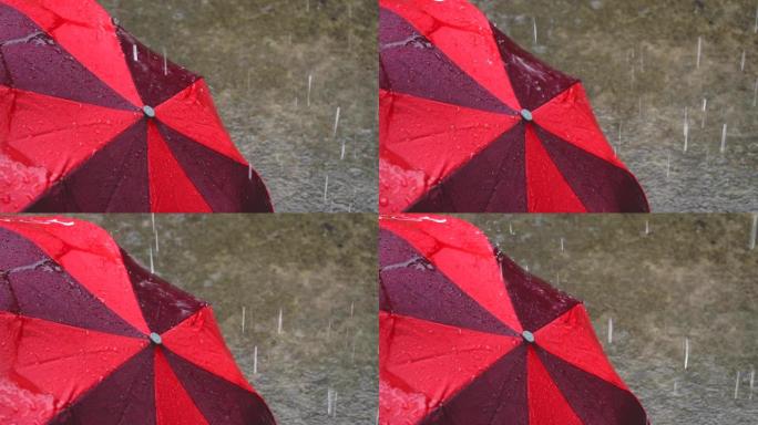 红色雨伞上的雨滴。