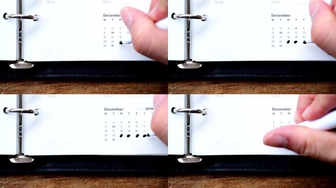 全高清慢动作视频镜头亚洲男性手标记奇斯马斯新年长周末日程表在日记日历计划