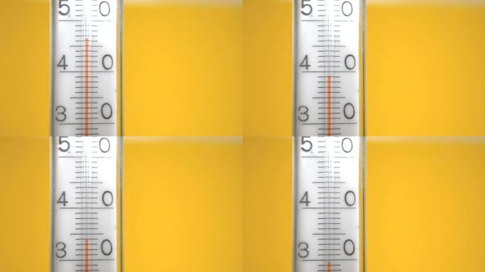 黄色背景上的温度计