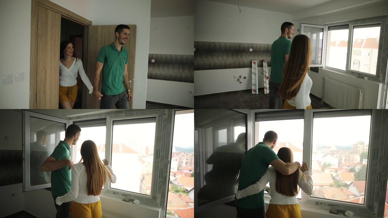 幸福的夫妇进入他们的新公寓