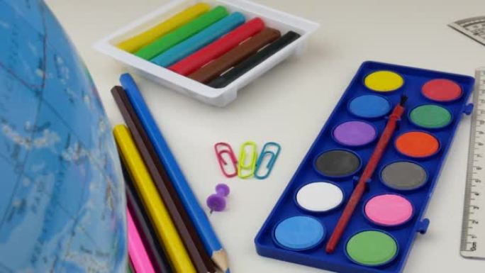 学校办公桌上有不同的彩色用品。回到学校的概念。