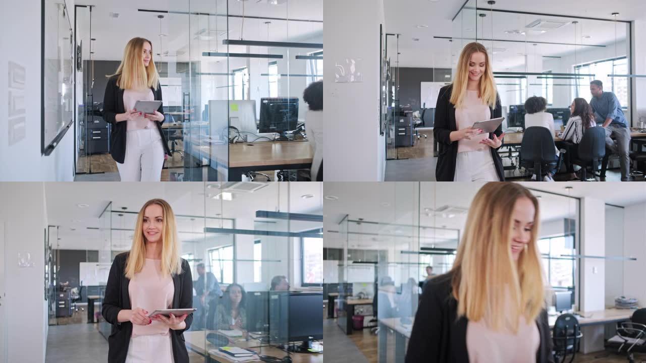 积极进取的女商人走过办公室并使用数字平板电脑