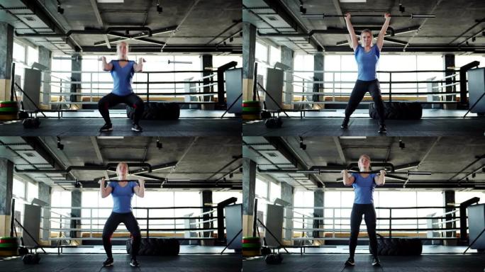 在健身房进行交叉训练时，强壮的女运动员举起杠铃并进行挺举运动
