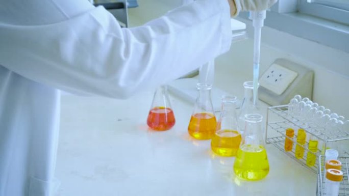 科学家在化学实验室测试天然产物提取物，油和生物燃料 (橙色溶液)