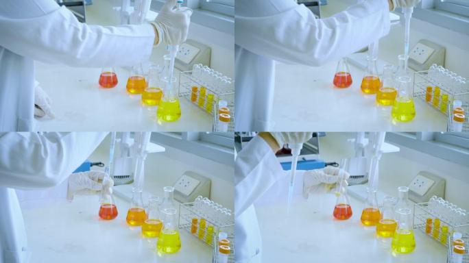科学家在化学实验室测试天然产物提取物，油和生物燃料 (橙色溶液)