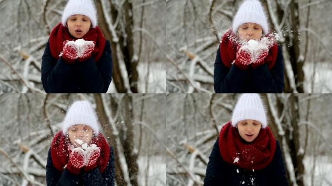 穿着白色针织帽，红领巾和连指手套的年轻女孩吹雪