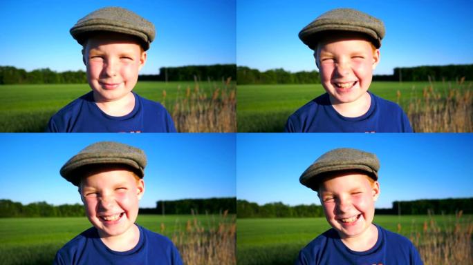 帽子里快乐男孩的肖像嘲笑乡村环境。可爱的英俊宝贝带着快乐的微笑看着镜头。脸上带着高兴的表情特写男孩子