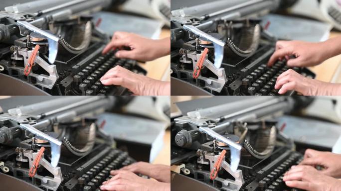 女人在旧打字机用打字机打文字。