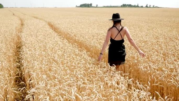 穿着黑色连衣裙和帽子的女人在球场上