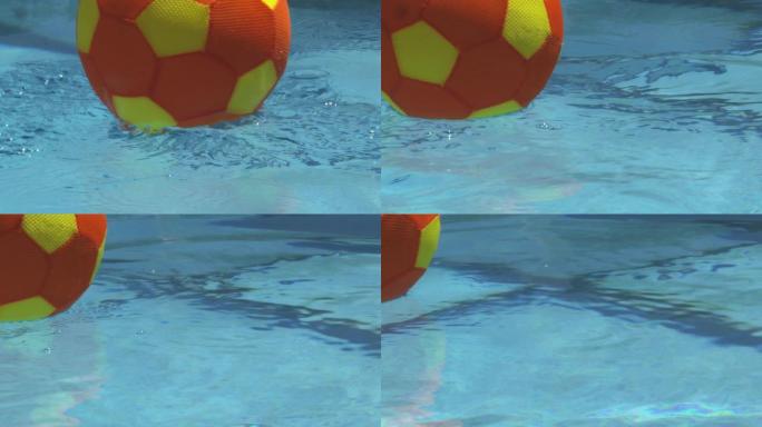 球的慢动作击中水池中的水，然后漂浮