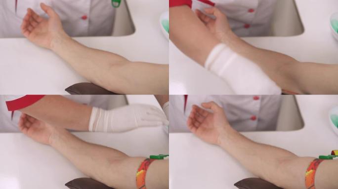 医生戴上手套将止血带放在患者手臂上的前视图。特写演示视频