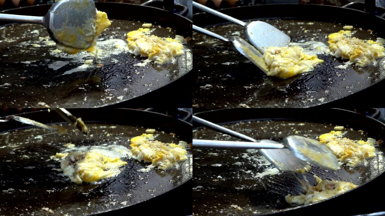 厨师烹饪Hoy Tod脆皮泰国牡蛎煎蛋卷。