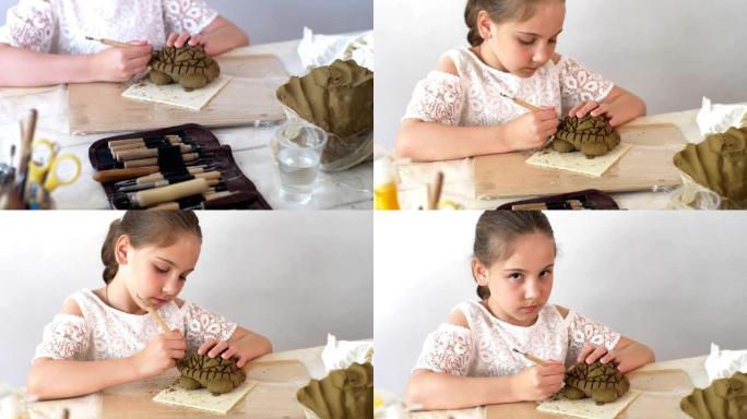小女孩在艺术工作室用特殊工具用湿粘土雕刻乌龟