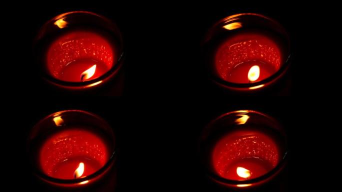 大型圆形红色纪念蜡烛在黑暗中燃烧