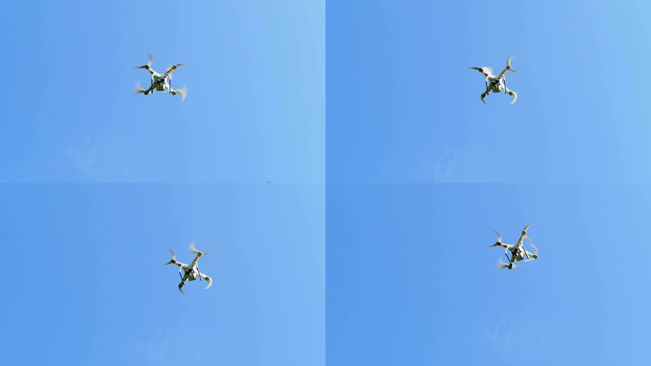 在湛蓝的天空中飞行的小型四轴飞行器