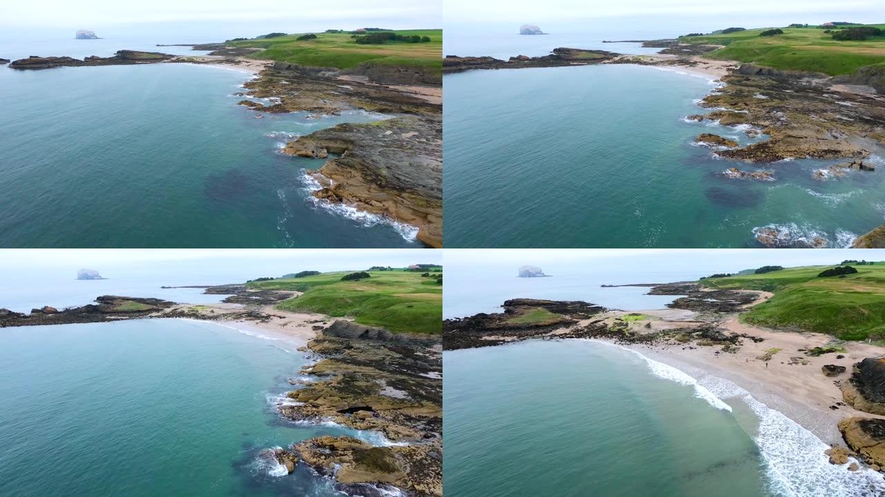 低音岩石的鸟瞰图-北塘鹅殖民地和绿色农田的家园，北贝里克北海的米尔西湾和豪路海滩