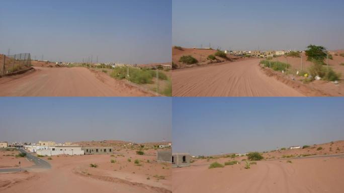 在中东阿拉伯联合酋长国靠近骆驼农场的沙质沙漠公路上驾驶汽车。快速镜头剪辑，快进。